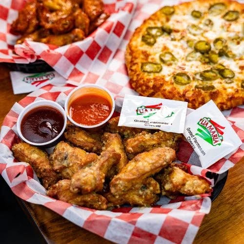 Clickable image showing Crispy chicken wings with two dipping sauces, and sachets of grated parmesan cheese with a cheesy pizza topped with jalapeanos. Should open an Instagram external link to the source image.