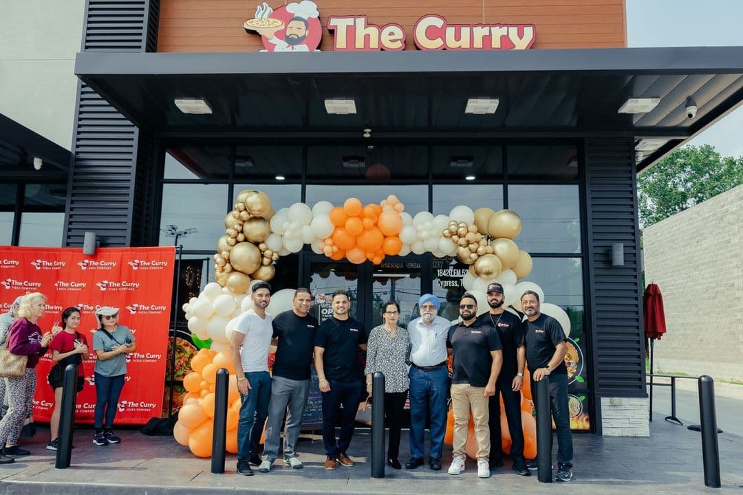 Clickable Picture of the grand opening of a new Curry Pizza resturant. Should open an Instagram external link to the source image.